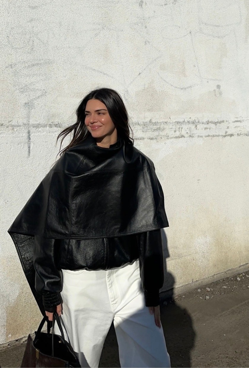 An image of Kendall Jenner wearing one of the best cape coats from Phoebe Philo with white trousers while out in Los Angeles.