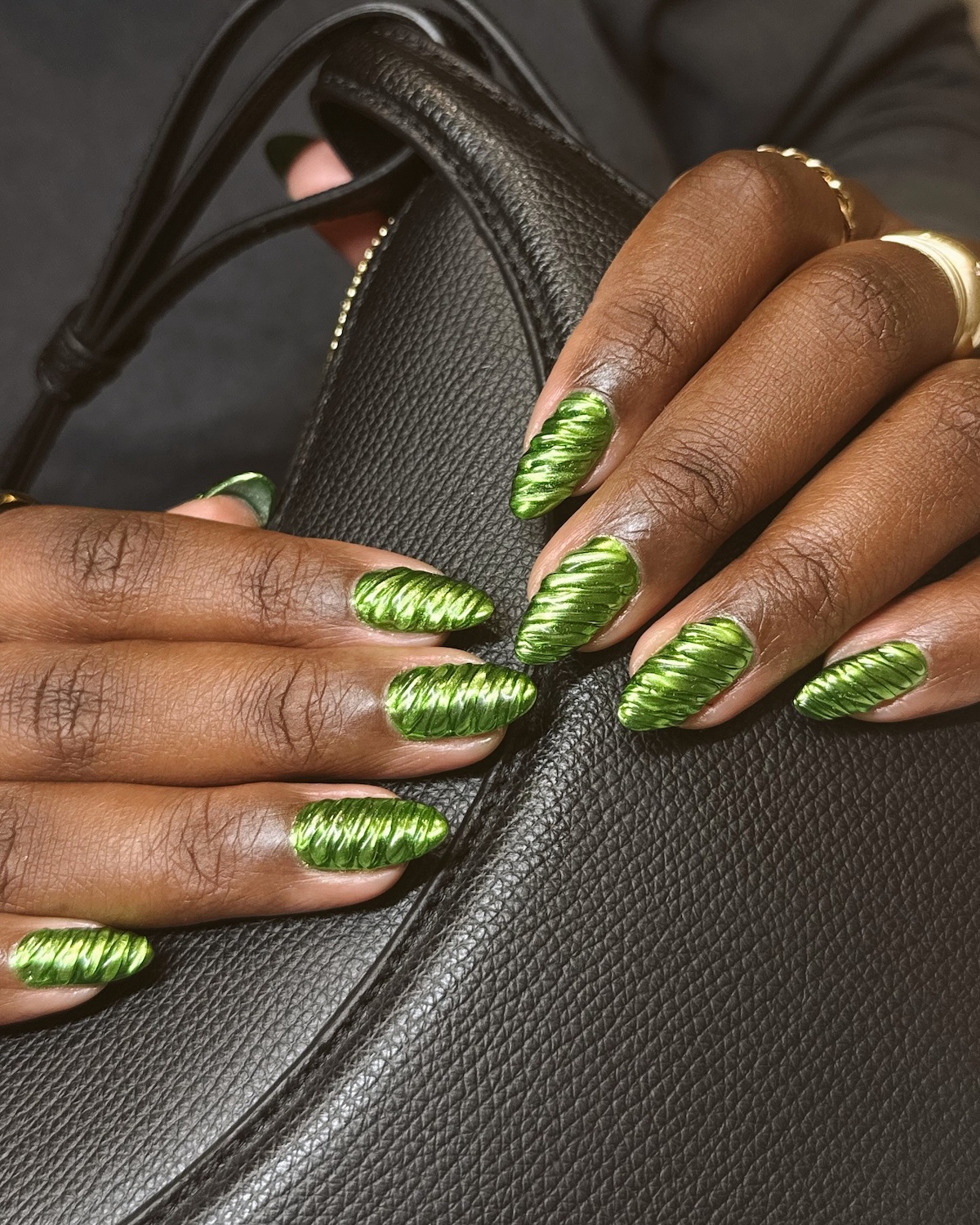 Metallic green textured manicure