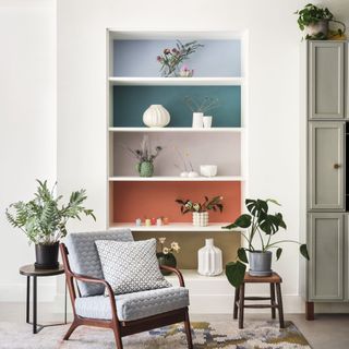 chair with cushion in front of shelving unit with block colours