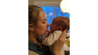 Gentle parenting illustrated by mum holding baby nose to nose