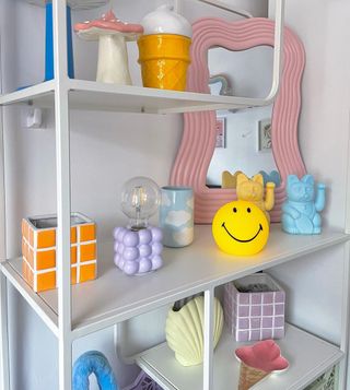 White bookshelf with pastel decorations