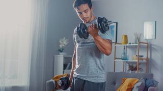 a photo of a man doing bicep curls at home