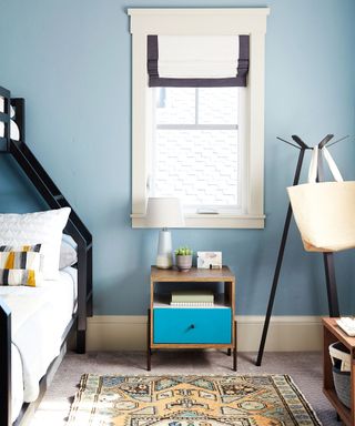 Blue bedroom with wood side table