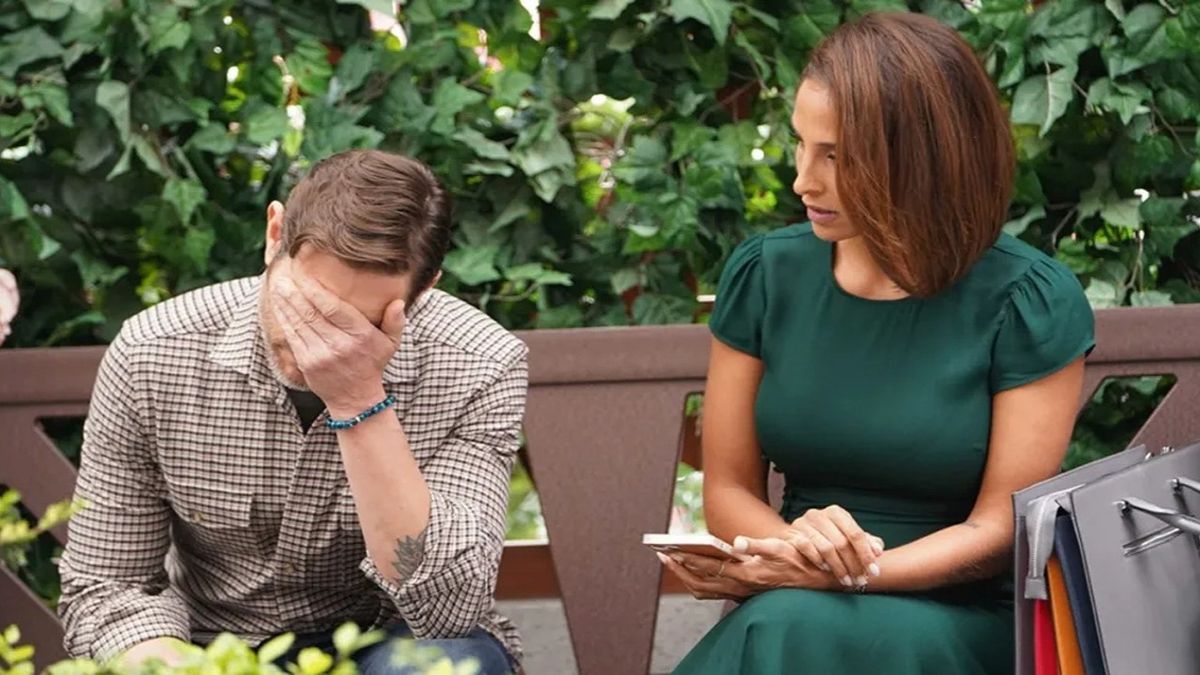 Michael Graziadei and Christel Khalil as Daniel and Lily on a park bench in The Young and the Restless