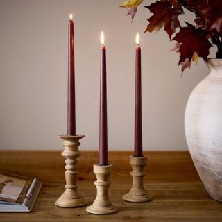 Taper Candles against a white wall.