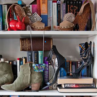 open shelf with books and fancy heels