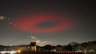 Eerie ring of red light flashes like a massive UFO above Italy