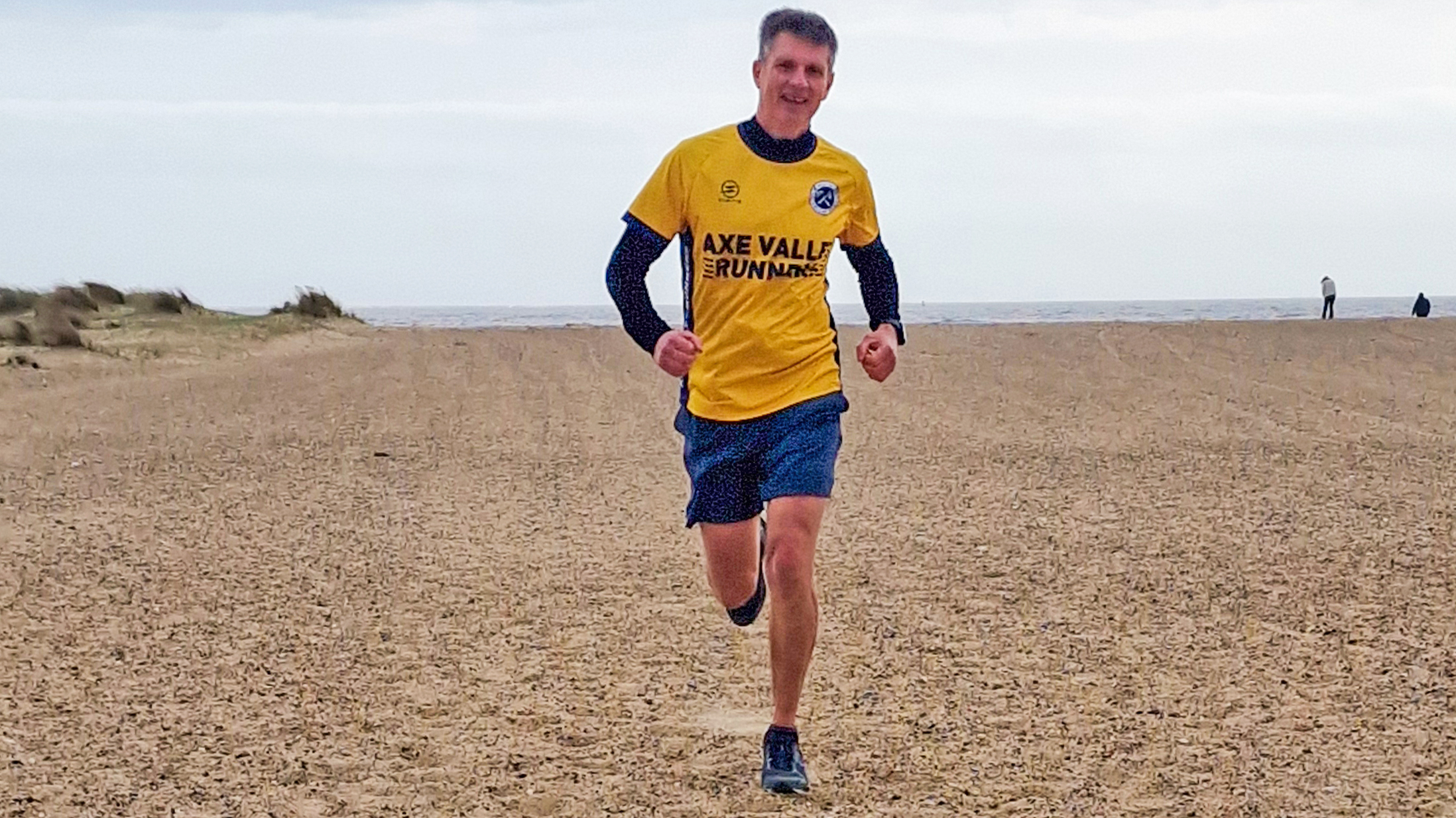 Pat running Great Yarmouth North Beach parkrun in the Lowa Skyterra