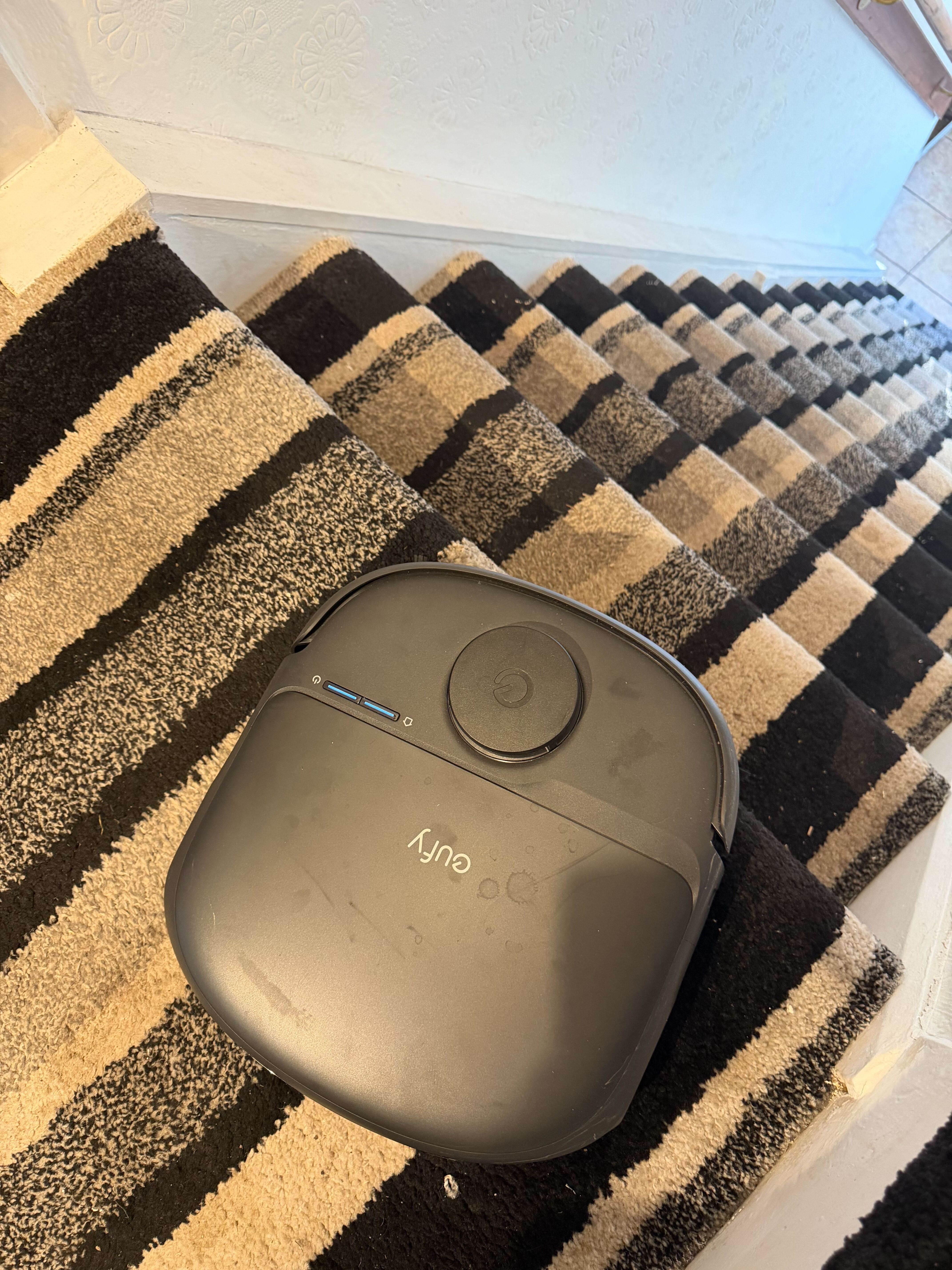 A robovac at the top of stairs