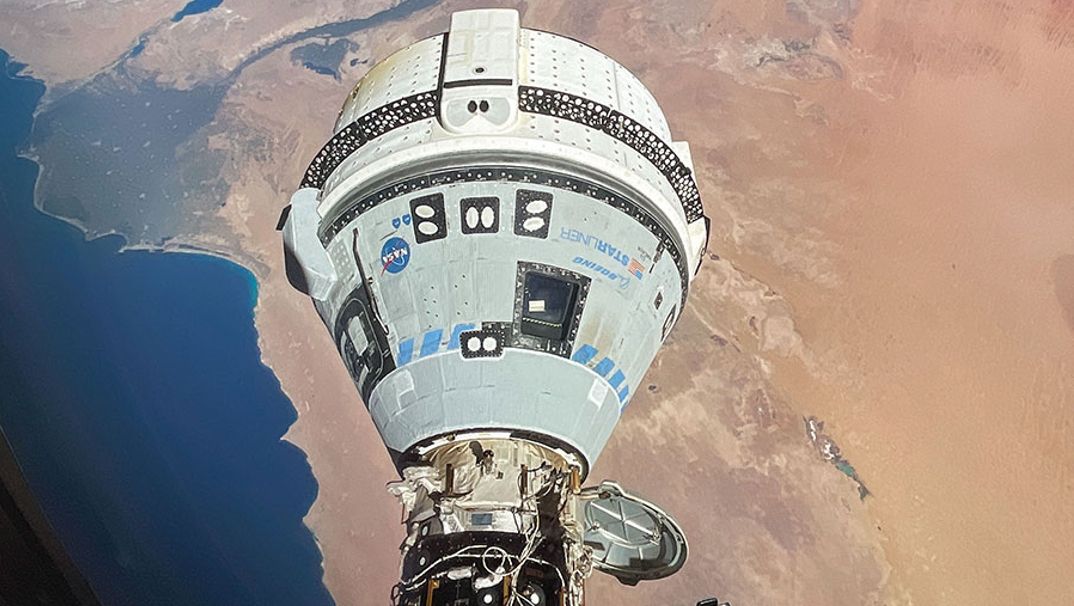 Boeing&#039;s white and blue Starliner spacecraft docked at the International Space Station in June 2024. 