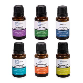 A set of six essential oil bottles with colorful labels and black lids