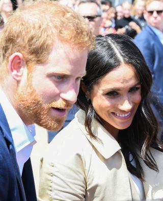 Closeup of Prince Harry and Meghan Markle shaking hands with well-wishers