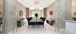 Saddle Stones, on elegant Old Avenue in St George’s Hill, boasts stylish interiors, including this formal dining room. £9.5m