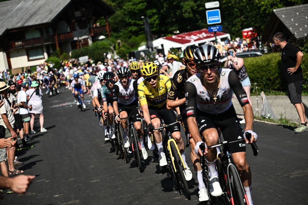 UAE Team Emirates' Polish rider Rafal Majka (R), Jumbo-Visma's US rider Sepp Kuss (2nd R) and Jumbo-Visma's Danish rider Jonas Vingegaard wearing the overall leader's yellow jersey (3rd R) lead the pack in cycles in the final ascent on the Col de Joux Plane during the 110th edition of the Tour de France cycling race, 152 km between Annemasse and Morzine Les Portes du Soleil, in the French Alps, on July 15, 2023. (Photo by Marco BERTORELLO / AFP)