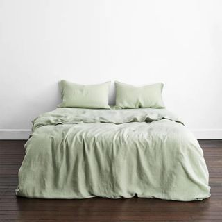 Bed with sage green linen sheets