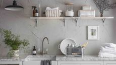 utility room with grey walls and sink