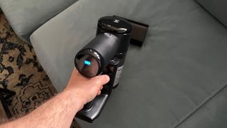The Ecovacs Deebot T30S Combo's handheld vacuum in action