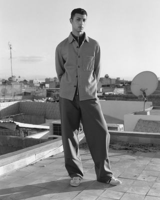 Man in black and white on Morocco rooftop