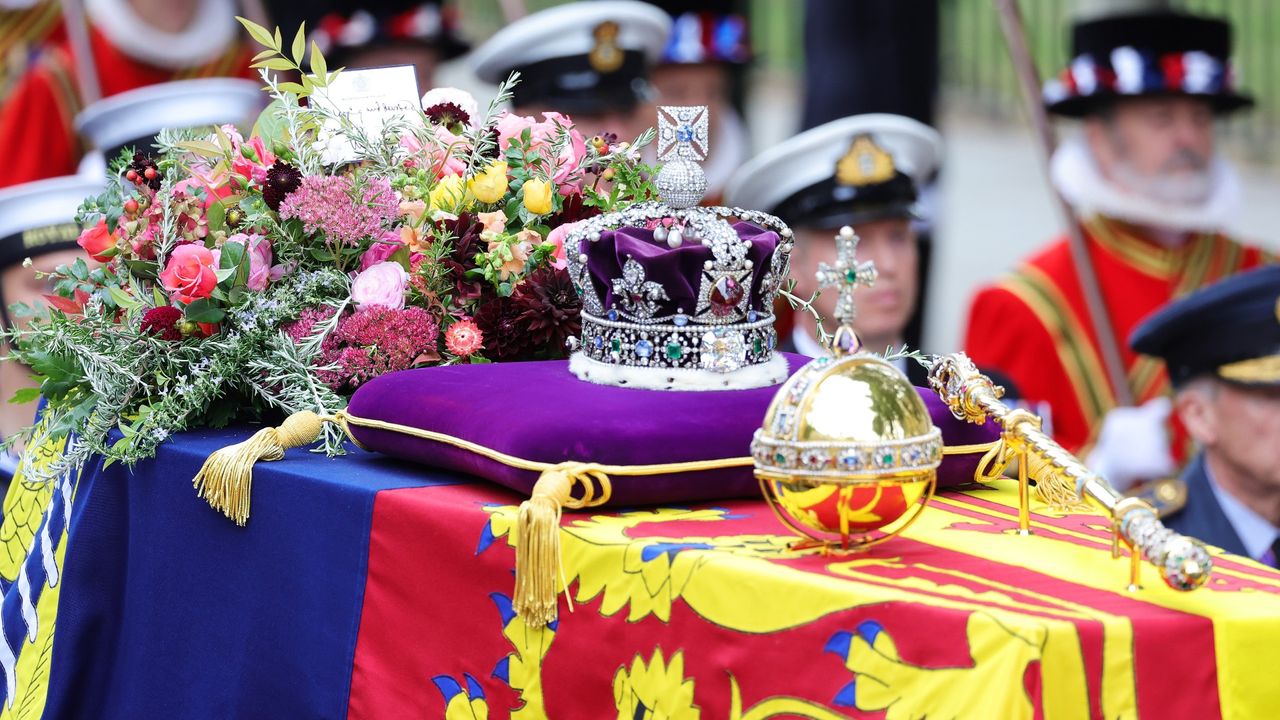 The coffin of Queen Elizabeth II with the Imperial State Crown resting on top is carried into Westminster Abbey