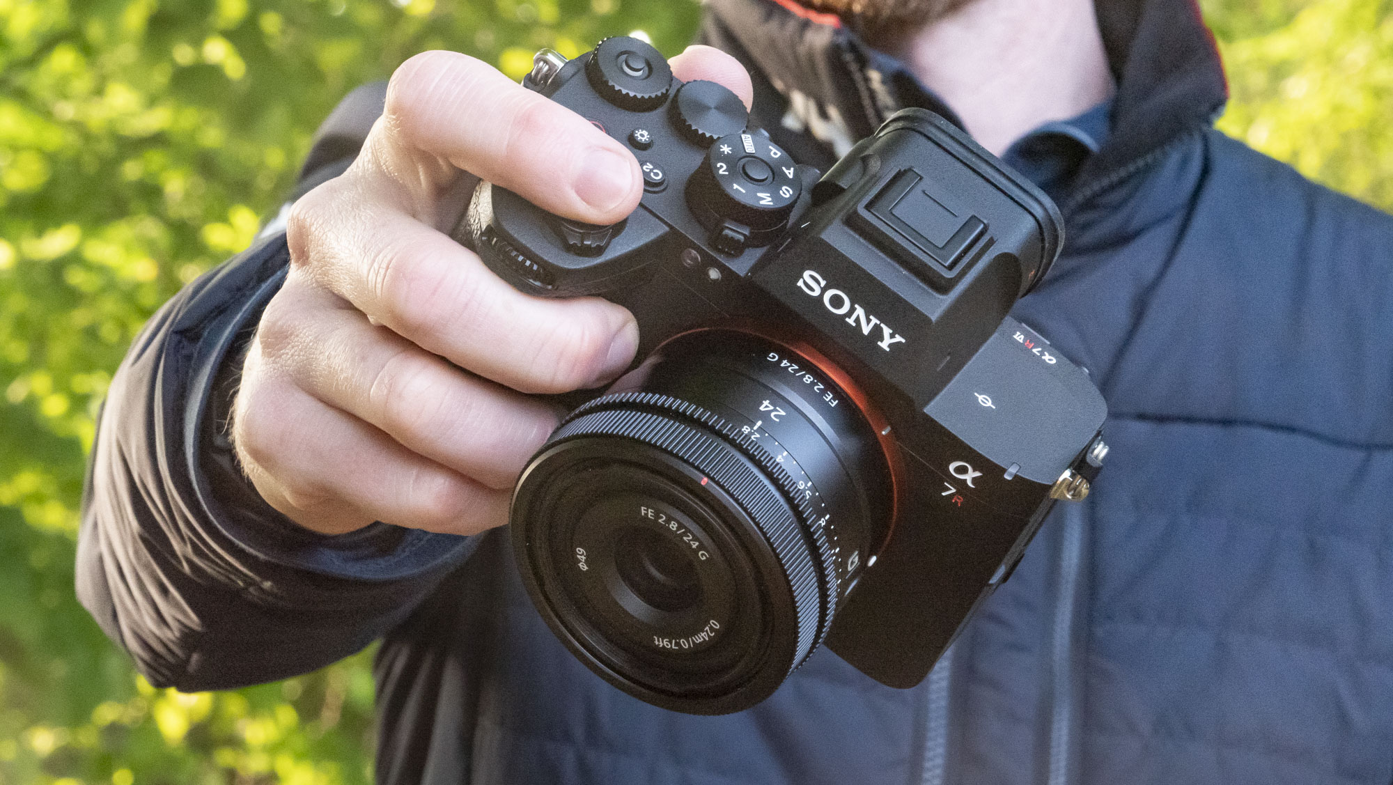 Sony A7R VI camera with 24mm F2.8 lens attached, in user's hands