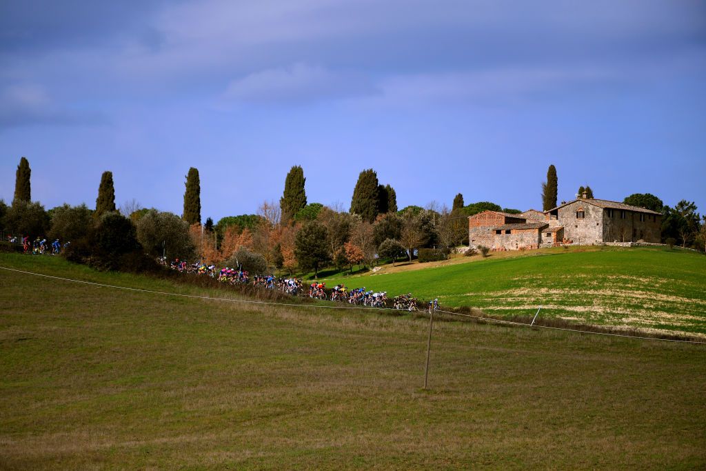 SIENA ITALY MARCH 06 The Peloton passing through Tuscany landscape during the Eroica 7th Strade Bianche 2021 Womens Elite a 136km race from Siena to Siena Piazza del Campo StradeBianche on March 06 2021 in Siena Italy Photo by Luc ClaessenGetty Images