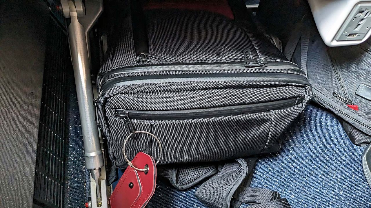 Waterfield Air Porter Travel Backpack under airplane seat.