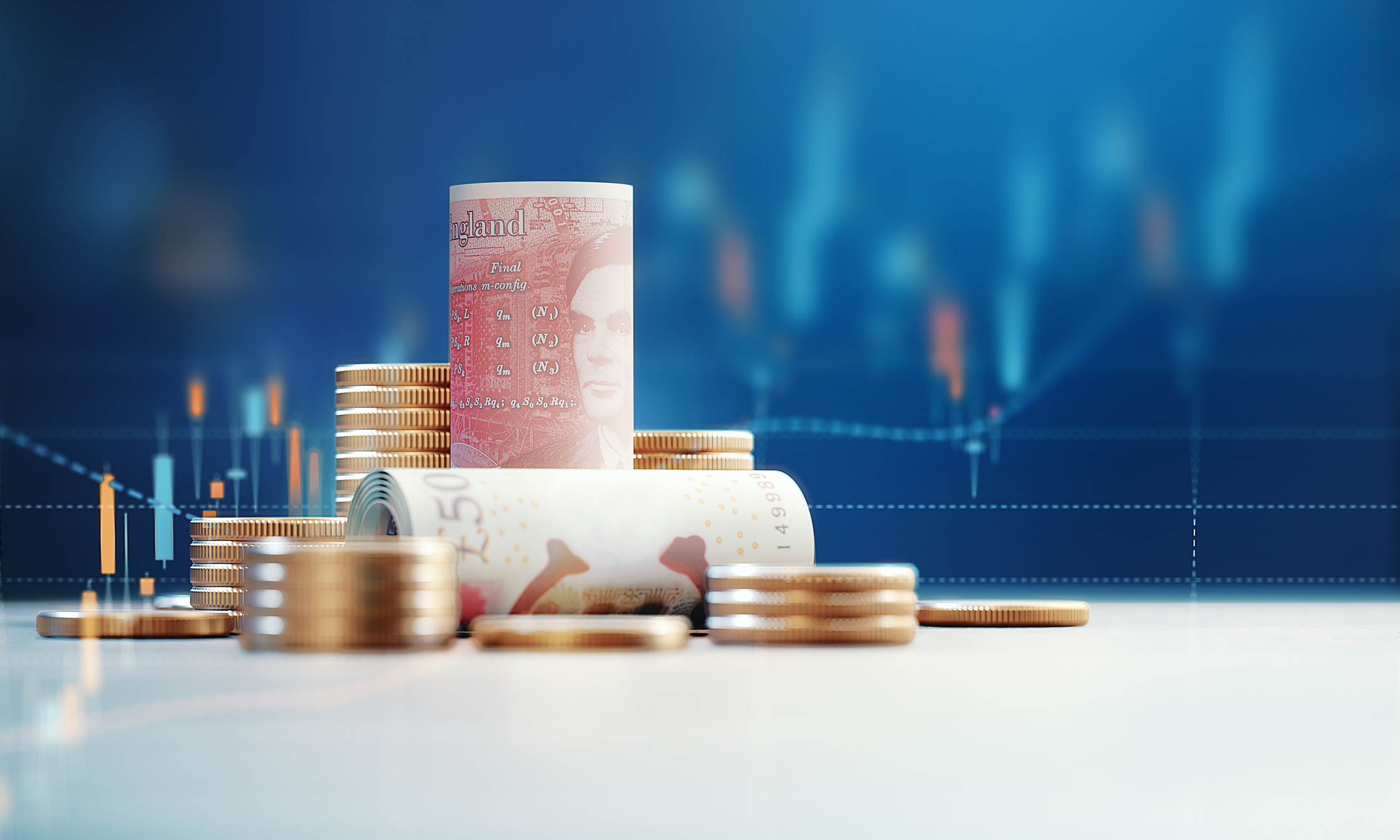 Cash 50 pound banknotes and coin stack before a stock market graph