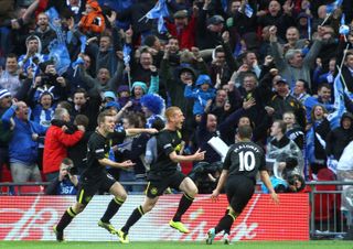 Ben Watson celebrates with teammates Callum McManaman and Shaun Maloney after scoring a late winning goal for Wigan Athletic in the 2013 FA Cup final against Manchester City at Wembley Stadium