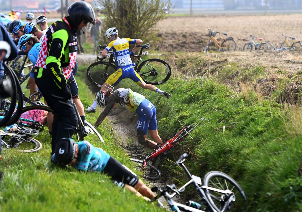 WEVELGEM BELGIUM MARCH 27 LR Cyril Lemoine of France and Team BB Hotels PB KTM Daniel Oss of Italy and Team Total Energies and Vito Braet of Belgium and Team Sport Vlaanderen Baloise involved in a crash during the 84th GentWevelgem in Flanders Fields 2022 Mens Elite a 2488km one day race from Ypres to Wevelgem GWE22 WorldTour on March 27 2022 in Wevelgem Belgium Photo by Tim de WaeleGetty Images