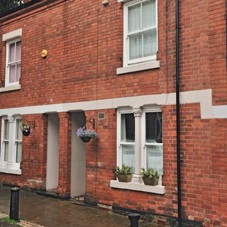 Row of red brick terraced houses with sash windows