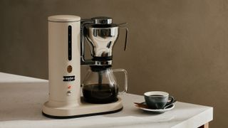 Aarke Coffee Maker in Sand on kitchen counter