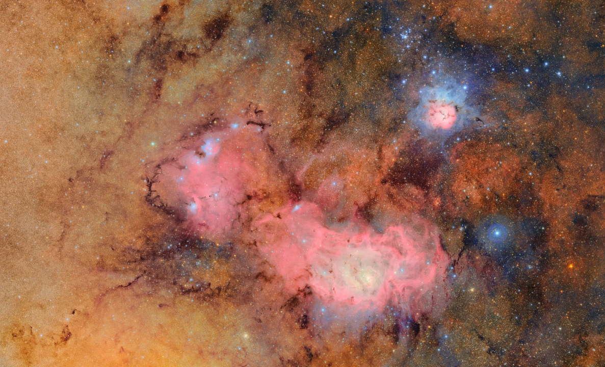 A pink globular cloud against a background of orange smoke