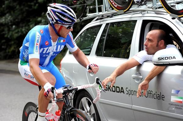 Italy's Luca Paolini drops back to the team car for a chat with Paolo Bettini.