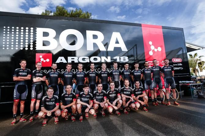 Bora-Argon 18 line up in front of the team bus.