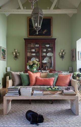 Wooden coffee table white ceiling beams, green walls, wooden cabinet