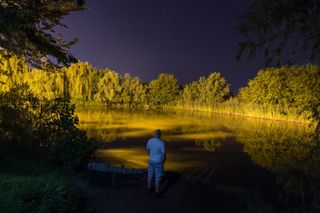 Fisherman in night Night Fishing Carp Rods starry night reflection on lake
