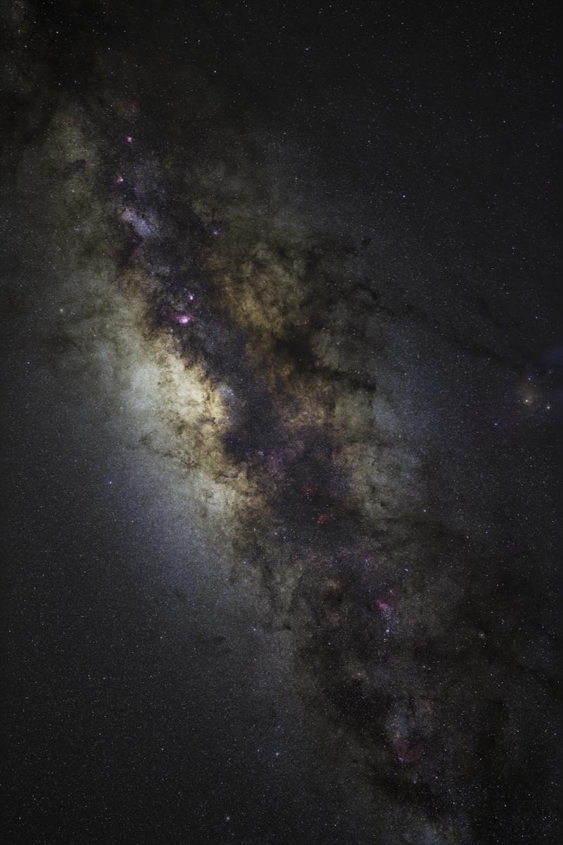 A starry view of the milky way streaks across the night sky, filling the image diagonally from the top left corner
