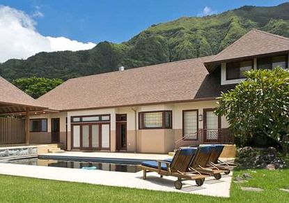 exterior of house with swimming pool and green lawn