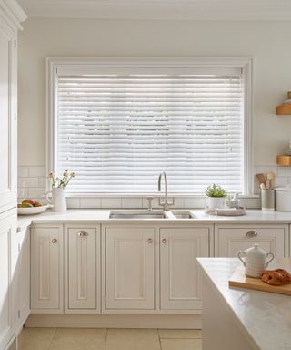 white kitchen with white venetian blind
