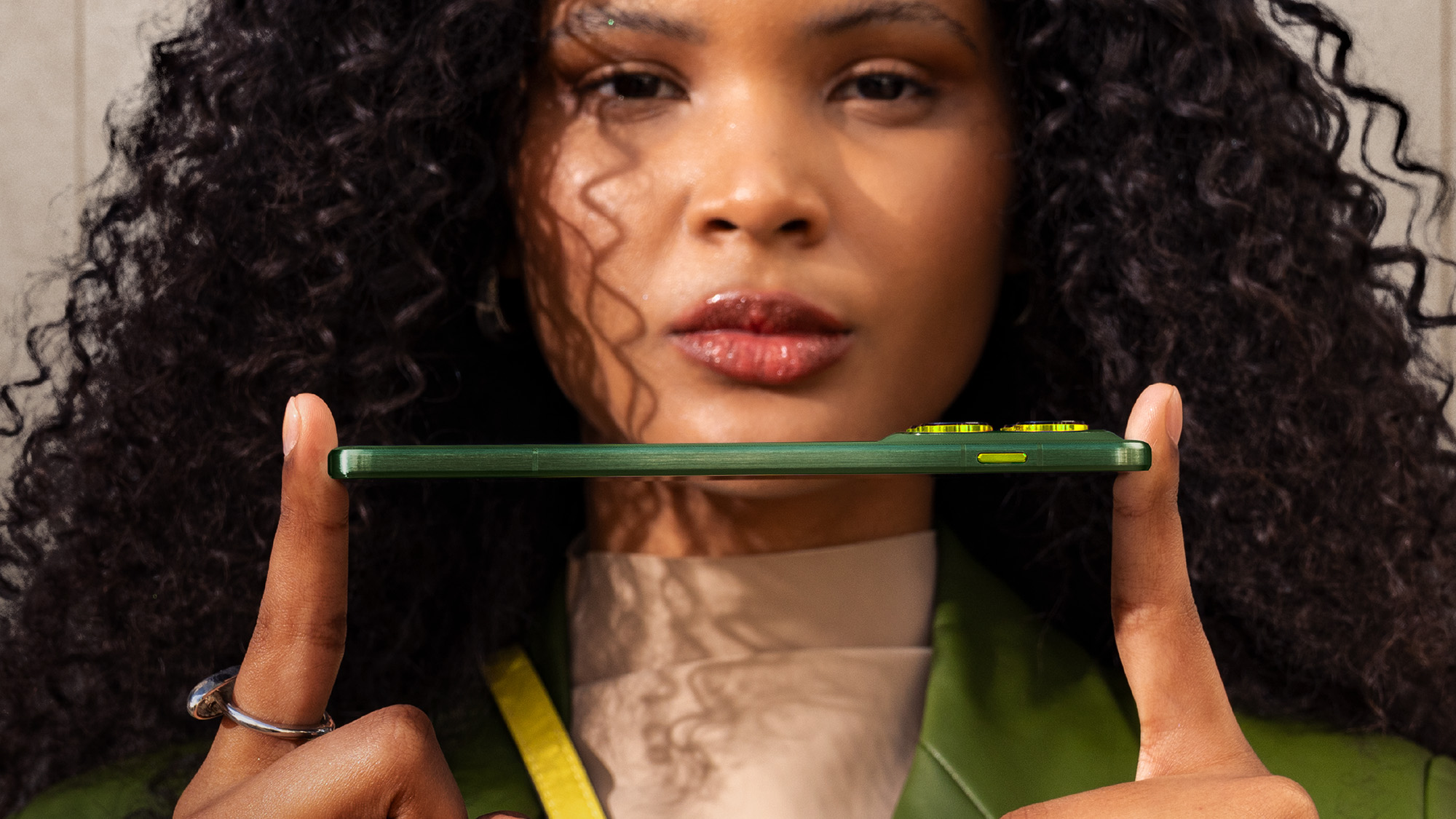 Moto Edge 70 held horizontally to show thinness.