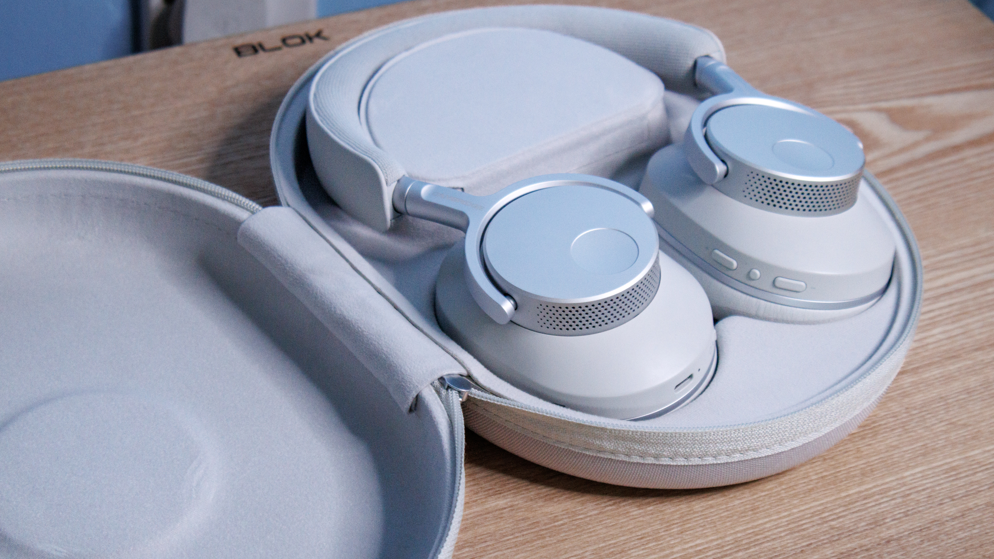 Cambridge Audio Melomania P100 SE headphones in their case on a table.