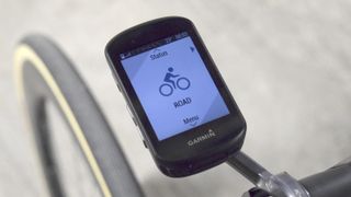 A Garmin Edge 530 Plus cycling computer, mounted to the front of a bike, with 'road' mode selected.