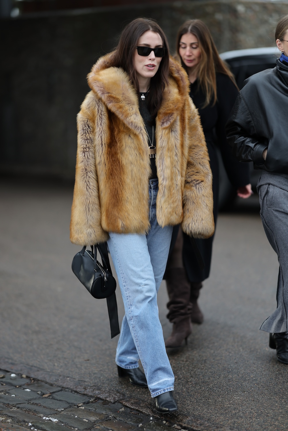 models at copenhagen fashion week wearing fur coats and colorful coats