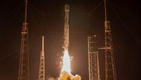 rocket launching from a launch pad at night