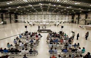 Onlookers take part in Sept. 19, 2011 ceremonies at the Mojave Air and Space Port. The Final Assembly, Integration and Test Hangar is designed to put together spaceships for Virgin Galactic.