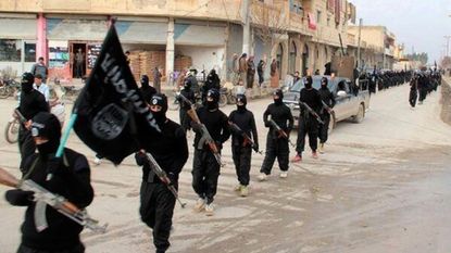 ISIS militants march in this file photo.