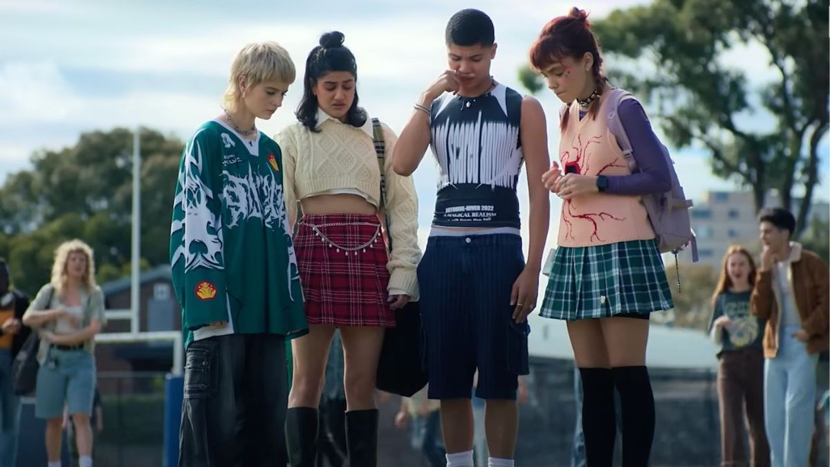 Harper, Amerie, Darren, and Quinni looking down in disgust at a dead bird in a backpack in Heartbreak High