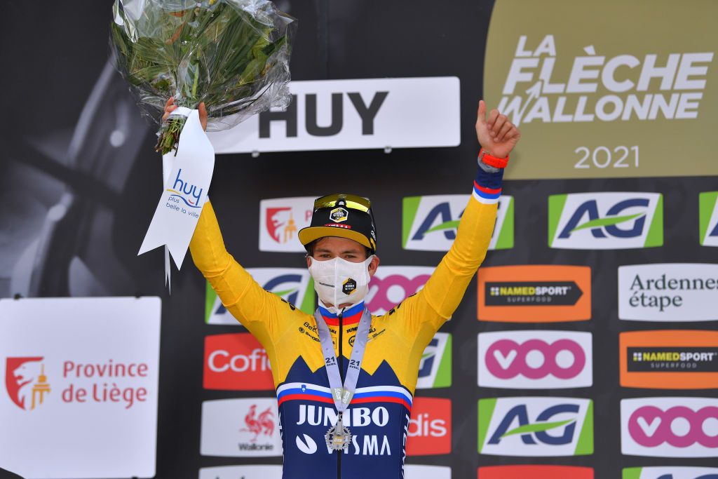MUR DE HUY BELGIUM APRIL 21 Podium Primoz Roglic of Slovenia and Team Jumbo Visma celebrates his 2nd classification during the 85th La Fleche Wallonne 2021 Men Elite a 1936km race from Charleroi to Mur de Huy 204m Mask Covid safety measures Flowers Silver medal FlecheWallonne on April 21 2021 in Mur de Huy Belgium Photo by Luc ClaessenGetty Images