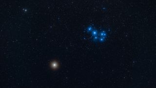 The red planet Mars beside the blue stars of the Pleiades, on March 30, 2019. This is a stack of 4 x 1-minute exposures with the 200mm lens at f/3.5 and Canon 6D MkII at ISO 800, plus a stack of two exposures taken through a Kenko Softon diffusion filter to add the enhanced glows, though there was enough high haze this night to add some natural glows. The camera on the Fornax Lightrack tracker. Images manually stacked and aligned as the difference in star positions at the bottom of the frame due to atmospheric refraction (the field was low in the west) made it impossible for Photoshop to align the images accurately. (Photo by: Alan Dyer/VW PICS/Universal Images Group via Getty Images)