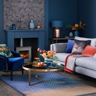 blue living room with armchair and fire place